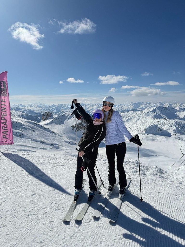 Two ChannelDock colleagues posing on skis in the mountains